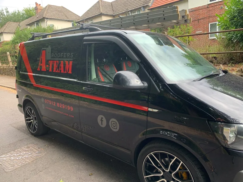 A Team Roofers branded van on site
